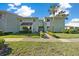 Inviting two-story building with fresh green siding, lush landscaping, and a clear blue sky at 515 Midway Dr # A, Ocala, FL 34472