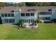 The condo's back patio provides a relaxing space with outdoor seating and direct access to the lush lawn and lake at 515 Midway Dr # A, Ocala, FL 34472