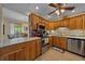 View of the eat-in kitchen offering granite countertops, stainless steel appliances, and wood cabinetry at 515 Midway Dr # A, Ocala, FL 34472
