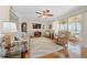 Comfortable living room with sliding glass doors to lanai, wood floors, ceiling fan, and neutral decor at 515 Midway Dr # A, Ocala, FL 34472