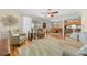 Bright living room with wood floors, comfortable seating, and natural light, open to kitchen and dining areas at 515 Midway Dr # A, Ocala, FL 34472
