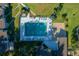 A clear swimming pool is surrounded by lounge chairs, umbrellas, landscaping, and condo buildings at 515 Midway Dr # A, Ocala, FL 34472