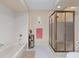 Clean bathroom with a tub, tiled walls, and a shower, featuring a glass door and a toilet at 8237 108Th Street Sw Rd, Ocala, FL 34481