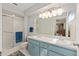 Bright bathroom with double sinks, updated cabinets, and a walk-in shower at 8237 108Th Street Sw Rd, Ocala, FL 34481