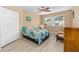 Comfortable bedroom featuring laminate flooring, a ceiling fan, and ample natural light at 8237 108Th Street Sw Rd, Ocala, FL 34481