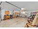 Spacious garage with storage cabinets, work bench, laundry area, and visible shelving for organization at 8237 108Th Street Sw Rd, Ocala, FL 34481