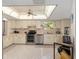 Bright kitchen features cream cabinets, stainless steel appliances, and tiled flooring at 8237 108Th Street Sw Rd, Ocala, FL 34481