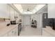 Well-lit kitchen features cream cabinets, stainless steel appliances, and unique lighting at 8237 108Th Street Sw Rd, Ocala, FL 34481