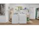 Functional laundry room with a washer, dryer, water heater, utility sink, and ample storage space at 8237 108Th Street Sw Rd, Ocala, FL 34481