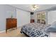 Light-filled bedroom featuring laminate flooring, ceiling fan, and access to lanai at 8237 108Th Street Sw Rd, Ocala, FL 34481