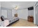 Cozy bedroom featuring laminate flooring, ceiling fan, and access to the lanai at 8237 108Th Street Sw Rd, Ocala, FL 34481