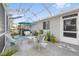 Outdoor patio with ample seating, an umbrella, a grill, and lush landscaping for relaxing and entertaining at 8237 108Th Street Sw Rd, Ocala, FL 34481