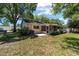 Lush backyard with trees, green grass, patio, and a partial view of the home at 8831 Sw 94Th Ln # H, Ocala, FL 34481