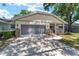 Charming single-story home showcasing a covered front porch, and a two-car garage at 8831 Sw 94Th Ln # H, Ocala, FL 34481