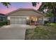 Charming single-story home showcasing a covered front porch, and a two-car garage at 8831 Sw 94Th Ln # H, Ocala, FL 34481
