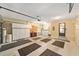 Spacious garage with ample storage cabinets, utility sink, and workbench, providing an organized workspace at 8831 Sw 94Th Ln # H, Ocala, FL 34481