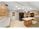 Eat-in kitchen features island, light countertops, black appliances, and light wood cabinetry at 8831 Sw 94Th Ln # H, Ocala, FL 34481