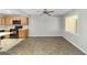 Open floorplan showing view of living room and eat-in kitchen with wood cabinets and black appliances at 8831 Sw 94Th Ln # H, Ocala, FL 34481