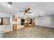 Open floorplan view of the living room area with kitchen in the background featuring wooden cabinetry at 8831 Sw 94Th Ln # H, Ocala, FL 34481