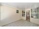 Enclosed patio with neutral tile, a small window, and a glass door leading to the exterior of the home at 8831 Sw 94Th Ln # H, Ocala, FL 34481