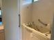 Bathroom featuring a walk-in tub, handrails, and tile flooring for safety and accessibility at 9288 Sw 93Rd Cir, Ocala, FL 34481