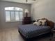 Bedroom features a window with shutters, wood floors, and dark furniture at 9288 Sw 93Rd Cir, Ocala, FL 34481