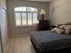 Bedroom features a window with shutters, wood floors, and a closet at 9288 Sw 93Rd Cir, Ocala, FL 34481