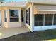 Exterior showcasing the home's screened-in porch with awning, and view of backyard and landscaping at 9288 Sw 93Rd Cir, Ocala, FL 34481