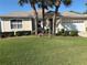 Beautiful single-story home featuring lush landscaping, a well-manicured lawn, and a two-car garage at 9288 Sw 93Rd Cir, Ocala, FL 34481