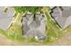 Aerial view of home's roof, backyard, landscaping, and screened lanai, surrounded by well-manicured lawn at 9591 Sw 70Th Loop, Ocala, FL 34481