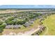 Gorgeous aerial view of an expansive community with lush greenery, a pristine golf course, and a tranquil pond at 9591 Sw 70Th Loop, Ocala, FL 34481