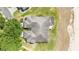 Overhead view of a home's roof and backyard, showing the screened lanai and the golf course bordering the property at 9591 Sw 70Th Loop, Ocala, FL 34481