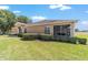 Exterior view of a screened in lanai and lush landscaping, which enhances privacy and charm at 9591 Sw 70Th Loop, Ocala, FL 34481