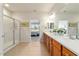 Bright bathroom features double sinks with wood cabinets and walk-in shower with glass door at 9591 Sw 70Th Loop, Ocala, FL 34481