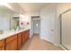 Bathroom with double vanity sinks, natural wood cabinets, and step-in shower at 9591 Sw 70Th Loop, Ocala, FL 34481