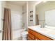 Bathroom with neutral-colored walls, a single sink vanity and a shower-tub combo with curtain at 9591 Sw 70Th Loop, Ocala, FL 34481