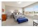 Cozy bedroom with natural light, carpet flooring, and a queen bed with stylish lamps at 9591 Sw 70Th Loop, Ocala, FL 34481