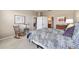 Well-lit bedroom featuring plush carpeting, a cozy rocking chair, and ensuite bathroom access at 9591 Sw 70Th Loop, Ocala, FL 34481