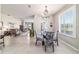 Bright dining room with chandelier lighting, plantation shutters, and an open layout to the living area at 9591 Sw 70Th Loop, Ocala, FL 34481