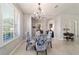 Dining area with a decorative chandelier, shuttered windows, and views to other living areas at 9591 Sw 70Th Loop, Ocala, FL 34481