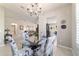 Dining area featuring a chandelier, floral chairs, and an open view into the kitchen and living spaces at 9591 Sw 70Th Loop, Ocala, FL 34481