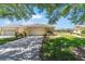 Charming home featuring a well-manicured lawn and landscaping, and an attached two-car garage at 9591 Sw 70Th Loop, Ocala, FL 34481