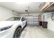 Spacious two car garage with a white car, overhead storage racks, and an automatic door opener at 9591 Sw 70Th Loop, Ocala, FL 34481