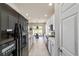 Modern kitchen design with stainless steel appliances, white cabinets, and tile flooring at 9591 Sw 70Th Loop, Ocala, FL 34481