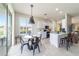 Bright kitchen and dining area with sleek countertops, a modern island, and a cozy breakfast nook at 9591 Sw 70Th Loop, Ocala, FL 34481