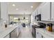 Stylish kitchen featuring modern appliances, white cabinets and marble countertops at 9591 Sw 70Th Loop, Ocala, FL 34481