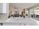 Open concept kitchen and living room with modern white countertops and stainless steel appliances at 9591 Sw 70Th Loop, Ocala, FL 34481