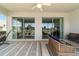 Relaxing screened lanai with comfy seating, ceiling fan, and peaceful views of the yard outside at 9591 Sw 70Th Loop, Ocala, FL 34481