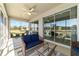 Cozy screened lanai with comfortable seating, ceiling fan, and serene views of the surrounding landscape at 9591 Sw 70Th Loop, Ocala, FL 34481