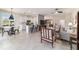 Spacious living room featuring tile floors, open floor plan to the kitchen, and stylish contemporary furnishings at 9591 Sw 70Th Loop, Ocala, FL 34481